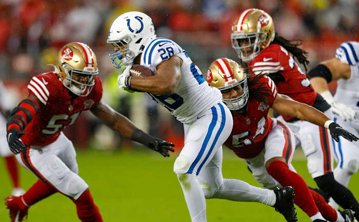 October 24, 2021; Indianapolis Colts running back Jonathan Taylor (28) is tackled by San Francisco 49ers linebackers Azeez Al-Shaair (51) and Fred Warner (54). © Robert Scheer/IndyStar / USA TODAY NETWORK